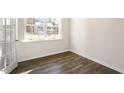 Bright room featuring a large window and luxury vinyl plank flooring at 1100 Ursa Major Ct, Wendell, NC 27591