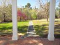 Lawn view from a column-lined front porch with a gravel path leading into the yard at 1188 Turner Rd, Creedmoor, NC 27522