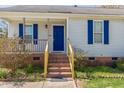 Close-up of entrance with blue door, brick steps, and covered porch at 133 Grassy Rio Ln, Garner, NC 27529