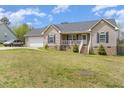 Charming single-Gathering home with light beige siding, complemented by a well-maintained green lawn at 141 Saige Ct, Burlington, NC 27217