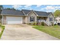 Charming single-Gathering home with light beige siding, complemented by a well-maintained green lawn at 141 Saige Ct, Burlington, NC 27217