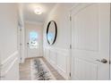 Bright foyer featuring a modern rug, decorative wall moulding and a door with glass panels at 144 E Victory View Ter # 66, Smithfield, NC 27577