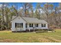 Beautiful one-story house with white walls, a nice porch, and a yard ready for gardening at 188 Hunter Ln, Zebulon, NC 27597