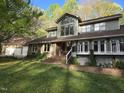 Attractive two-story home with brick walkway, expansive deck, and mature landscaping at 2000 Mountain Laurel Dr, Clayton, NC 27527