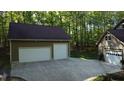 Spacious three car garage with ample parking and adjacent to wooded area at 2000 Mountain Laurel Dr, Clayton, NC 27527