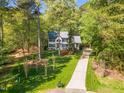 Inviting home surrounded by lush trees and a long driveway, promising privacy and tranquility at 201 Wortham Dr, Raleigh, NC 27614