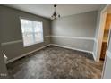 Inviting dining room with neutral walls, trim accents, and a modern light fixture at 247 Anna St, Lillington, NC 27546