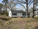 Traditional one-story home with white siding, a brick foundation, and a well-manicured front yard at 2904 Jefferson Davis Hwy, Sanford, NC 27332