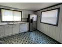 Functional kitchen boasts white cabinets, stainless steel refrigerator, and a window view at 2904 Jefferson Davis Hwy, Sanford, NC 27332