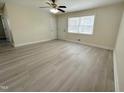 Bright living room featuring neutral walls, new flooring and natural light from a window at 313 Main St, Knightdale, NC 27545