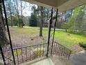 View from the porch with decorative railing overlooking a sprawling, green front lawn at 313 Main St, Knightdale, NC 27545