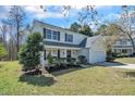 Beautiful home featuring a landscaped yard and classic architectural details, creating a welcoming ambiance at 3316 Perkins Ridge Rd, Raleigh, NC 27610