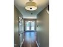Inviting hallway with hardwood floors and neutral paint, leading to the back patio at 3316 Perkins Ridge Rd, Raleigh, NC 27610