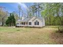 Traditional home exterior with a covered front porch, nestled on a spacious lot with mature trees and landscaping at 340 Castleberry Rd, Clayton, NC 27527