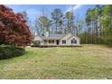 Inviting exterior view of a home featuring a classic front porch, accented by lush greenery and vibrant trees at 340 Castleberry Rd, Clayton, NC 27527