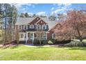 Lovely two-story brick home with a welcoming front porch and manicured landscaping, perfect for families at 3601 Tartancroft Pl, Fuquay Varina, NC 27526
