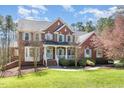 Lovely two-story brick home with a welcoming front porch and manicured landscaping, perfect for families at 3601 Tartancroft Pl, Fuquay Varina, NC 27526