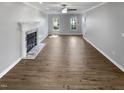 Bright living room with fireplace, wood floors, and ample natural light at 4216 High Mountain Dr, Raleigh, NC 27603