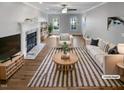 Bright living room with fireplace, wood floors, and ample natural light at 4216 High Mountain Dr, Raleigh, NC 27603