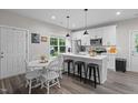 Bright kitchen with a breakfast bar, stainless appliances, and abundant white cabinetry at 501 E Granville St, Dunn, NC 28334