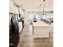Modern kitchen with stainless steel appliances, island, and an open layout at 5117 Farm Barn Ln, Raleigh, NC 27603