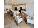 Eat-in kitchen features modern appliances, bar seating at the kitchen island, and a cozy dining area at 5117 Farm Barn Ln, Raleigh, NC 27603
