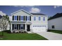 Charming two-story home with a two-car garage, black shutters, and well-manicured lawn at 55 Cordoba Dr, Franklinton, NC 27525