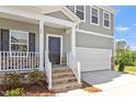 Inviting front entrance with stone-accented steps and a covered porch for a warm welcome at 55 Cordoba Dr, Franklinton, NC 27525