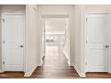 Inviting hallway with hardwood floors and neutral paint, leading to open living spaces at 5800 Agrinio Way, Raleigh, NC 27603