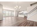 Open-concept living space featuring hardwood floors, natural light, and a staircase at 5800 Agrinio Way, Raleigh, NC 27603
