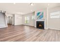 Spacious living room with hardwood floors, fireplace, and lots of natural light at 5800 Agrinio Way, Raleigh, NC 27603