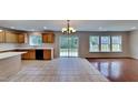 Spacious kitchen with tile floors, cabinets, black appliances, and lots of natural light at 613 Ashburn Ln, Durham, NC 27703