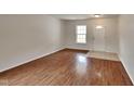 Bright living room with hardwood floors, neutral walls, and lots of natural light at 613 Ashburn Ln, Durham, NC 27703