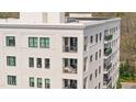Close-up of a pristine white brick condo with black trimmed windows and multiple balconies at 620 Wade Ave # 506, Raleigh, NC 27605