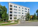 Stunning five-story building with white brick, black-framed windows, and private balconies at 620 Wade Ave # 506, Raleigh, NC 27605