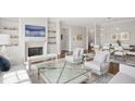 Bright living room with modern decor, fireplace, built-in shelving, and an open concept to the dining area at 620 Wade Ave # 506, Raleigh, NC 27605