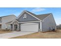 Contemporary single-Gathering home showcasing a two-car garage and stylish stone and siding exterior at 63 Mable Court # 6, Lillington, NC 27546