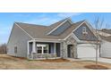 Beautiful craftsman-style home with stone accents, covered porch, and attached two-car garage at 63 Mable Court # 6, Lillington, NC 27546