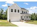 Beautiful two-story home with a covered porch, showcasing classic design elements and a spacious two-car garage at 65 Cordoba Dr, Franklinton, NC 27525