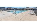 Community pool surrounded by lounge chairs on a sunny day at 76 Commons Cir, Clayton, NC 27520