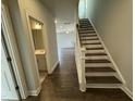 Inviting entryway with hardwood floors, staircase, and views into the open-concept living spaces at 765 Portland Rose Dr, Knightdale, NC 27545
