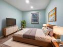 Cozy bedroom featuring neutral walls, light-colored floor, and a large window at 8125 Park Side Dr, Raleigh, NC 27612