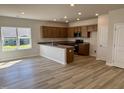 Open-concept kitchen boasts ample cabinetry and granite countertops with modern finishes at 84 Commons Cir, Clayton, NC 27520