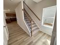 Bright foyer showcases a staircase with carpeted steps and black iron balusters at 84 Commons Cir, Clayton, NC 27520