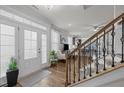 Inviting foyer featuring hardwood floors, staircase with iron spindles, and plenty of natural light at 8410 Zinc Autumn Path, Raleigh, NC 27615
