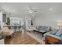 Spacious living room featuring hardwood floors, neutral decor, and an open layout to the kitchen at 8410 Zinc Autumn Path, Raleigh, NC 27615
