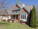 Attractive brick home with pristine lawn and mature landscaping at 8417 Henderson Rd, Apex, NC 27539