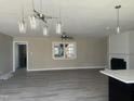 Bright, open-concept living room with modern lighting and a fireplace that offers comfort and style at 915 Knight Dr, Durham, NC 27712