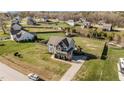 Aerial view of a gray two-story home with large lawn, surrounded by a wooden fence at 1036 Butterfly Cir, Wake Forest, NC 27587