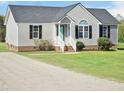 Inviting single-story home featuring light siding, black shutters, and a well-kept lawn and driveway at 105 Seminole Dr, Wendell, NC 27591